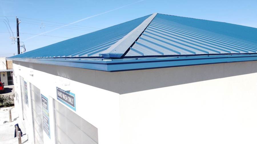 Blue metal roof and matching trim on a commercial car wash