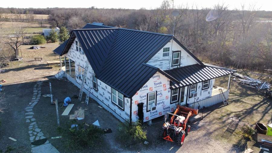 Black metal roof and new house wrap on a farmhouse remodel