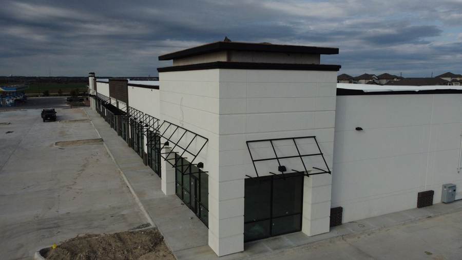 Steel awning frames along a new retail center